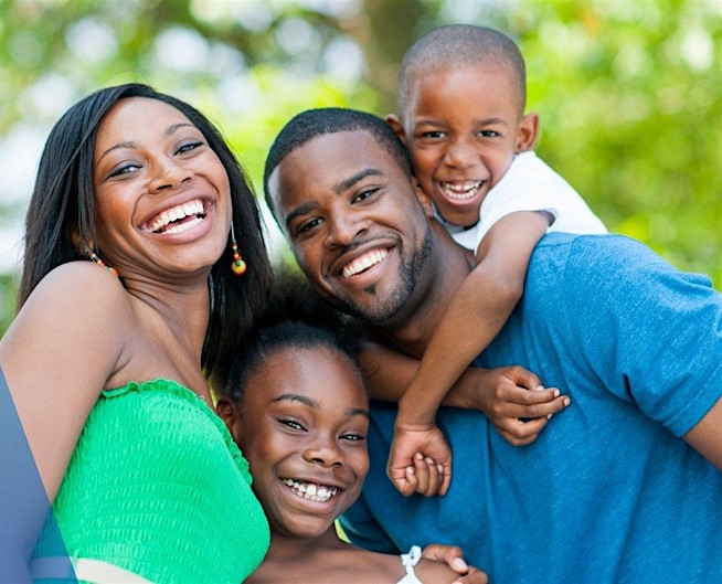 family smiling at camera